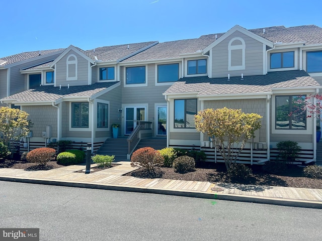multi unit property featuring roof with shingles