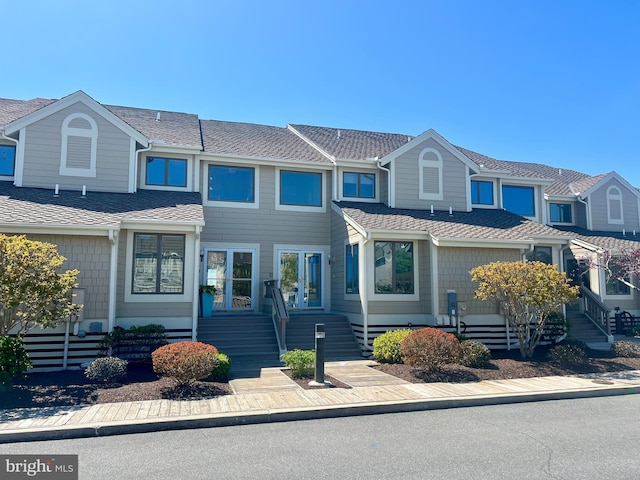 townhome / multi-family property with a shingled roof