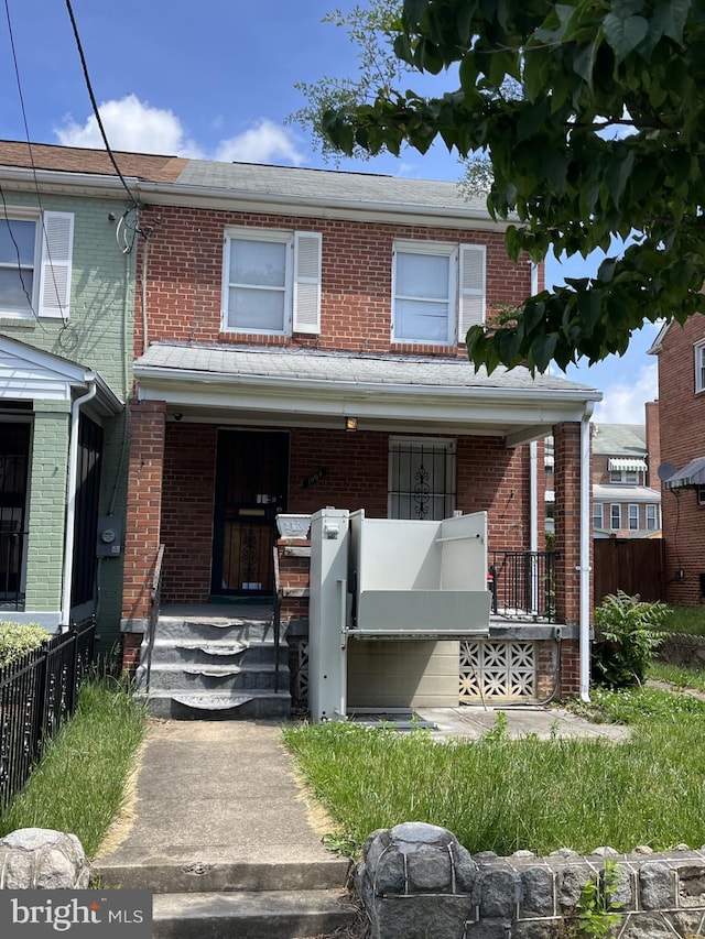 1904 U Pl SE, Washington, DC 20020 - view of property featuring covered porch, brick siding, and fence