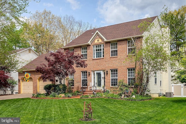colonial house with an attached garage, brick siding, a front yard, concrete driveway, and cooling unit