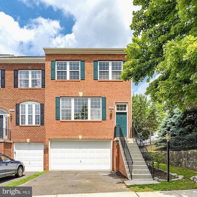 11559 Cavalier Landing Ct, Fairfax, VA 22030 - multi unit property featuring a garage, asphalt driveway, and brick siding