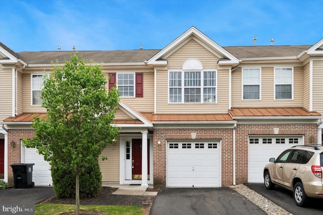327 Amy Way, Riverton, NJ 08077 - view of property with brick siding, a garage, driveway, and a standing seam roof