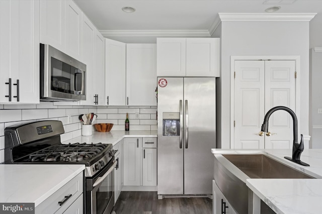 327 Amy Way, Riverton, NJ 08077 - kitchen featuring appliances with stainless steel finishes, a sink, light stone countertops, crown molding, and white cabinetry