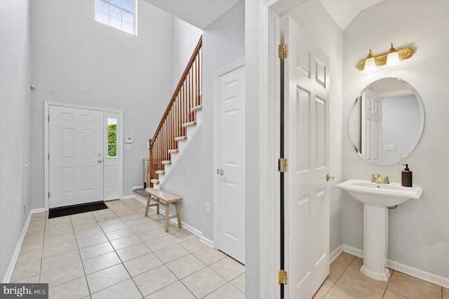 327 Amy Way, Riverton, NJ 08077 - entrance foyer with healthy amount of natural light, light tile patterned flooring, stairway, a high ceiling, and baseboards