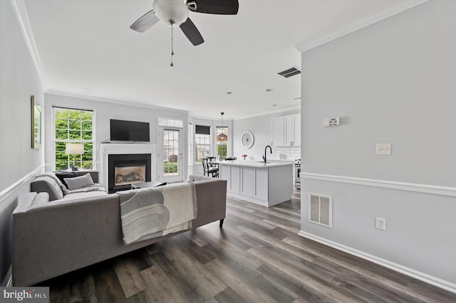 327 Amy Way, Riverton, NJ 08077 - living area with crown molding, a glass covered fireplace, ceiling fan, dark wood finished floors, and baseboards