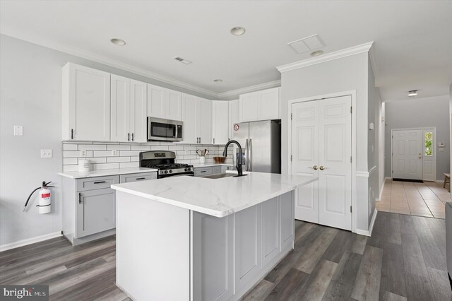 327 Amy Way, Riverton, NJ 08077 - kitchen featuring stainless steel appliances, a sink, decorative backsplash, an island with sink, and light stone countertops