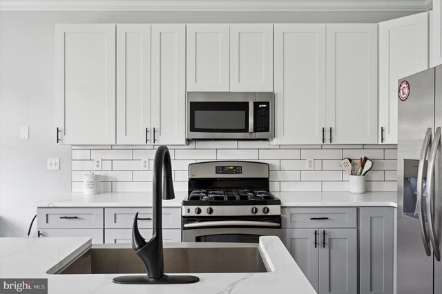 327 Amy Way, Riverton, NJ 08077 - kitchen with appliances with stainless steel finishes, decorative backsplash, light stone counters, and a sink