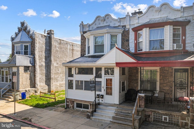 939 N 50th St, Philadelphia, PA 19131 - townhome / multi-family property with entry steps, stone siding, and cooling unit