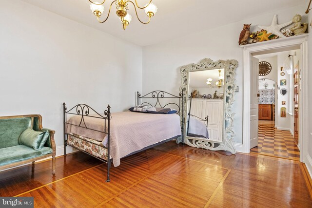541 Madison Ave, York, PA 17404 - bedroom featuring baseboards, wood finished floors, and a notable chandelier