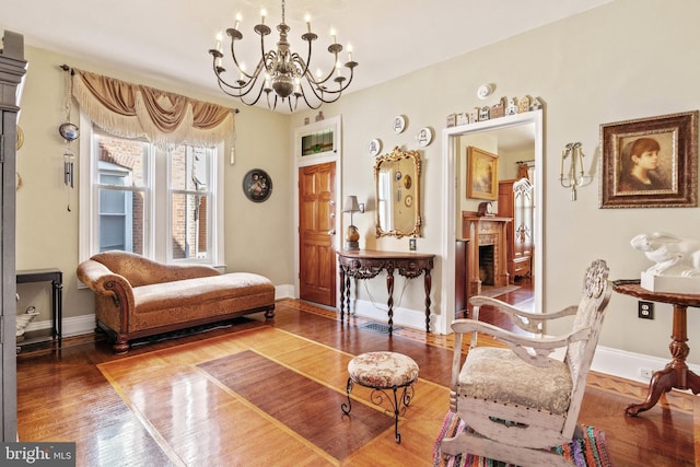 541 Madison Ave, York, PA 17404 - living area with baseboards, wood finished floors, a chandelier, and a fireplace