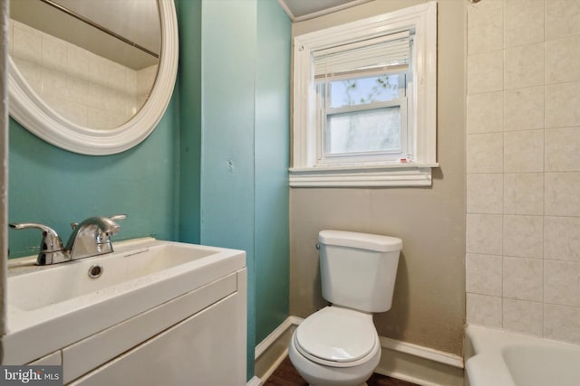 full bathroom with baseboards, vanity, and toilet
