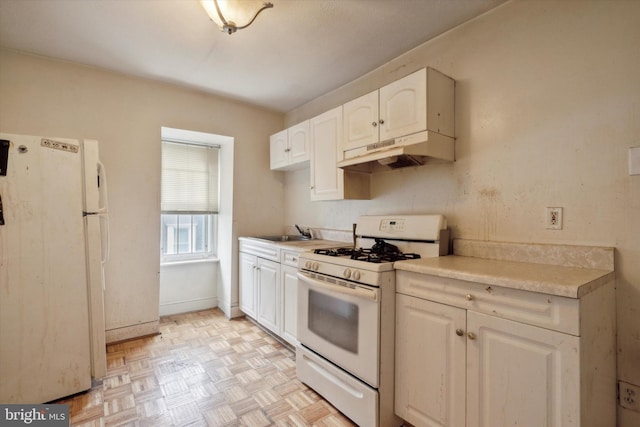 kitchen featuring light countertops, a sink, under cabinet range hood, white appliances, and white cabinetry