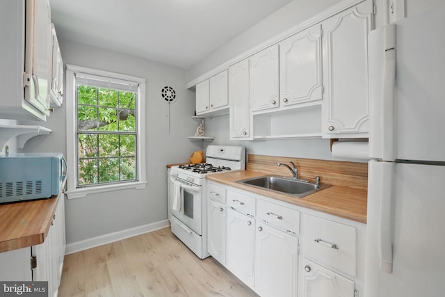 6618 Boulevard Vw Unit C1, Alexandria, VA 22307 - kitchen featuring white appliances, open shelves, butcher block counters, light wood-style floors, and white cabinetry