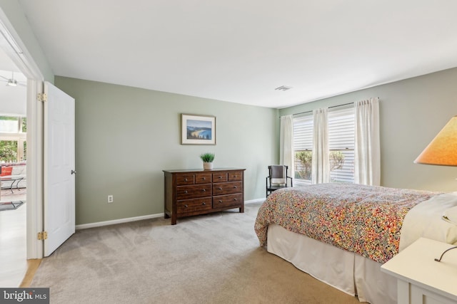 bedroom featuring light carpet and baseboards
