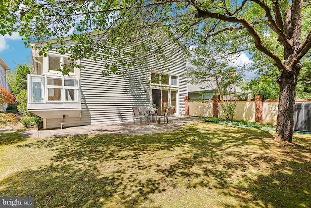back of house featuring fence and a patio area
