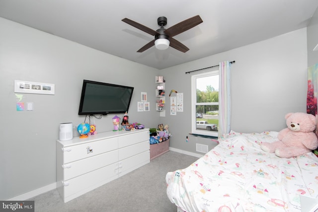 carpeted bedroom featuring baseboards, a ceiling fan, and visible vents