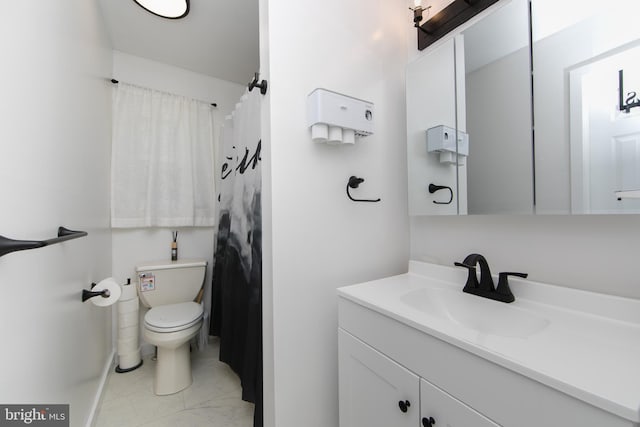 full bath featuring vanity, marble finish floor, baseboards, and toilet