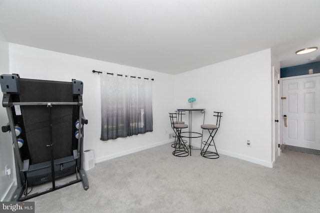 interior space with carpet floors and baseboards