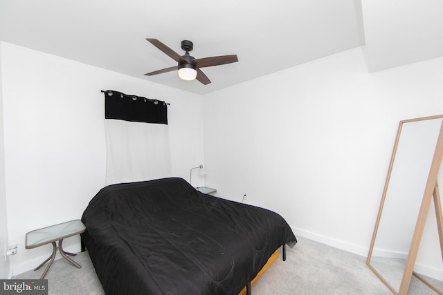 bedroom featuring baseboards, carpet flooring, and a ceiling fan