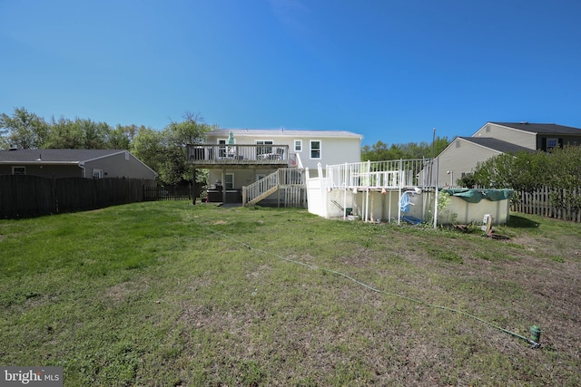 view of yard featuring a fenced backyard, a fenced in pool, a deck, and stairway