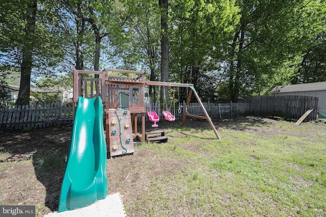 view of jungle gym featuring a fenced backyard and a lawn