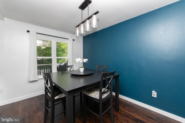 dining room with baseboards and wood finished floors