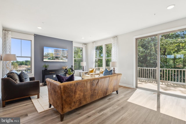 living room featuring light wood-style floors, recessed lighting, and baseboards
