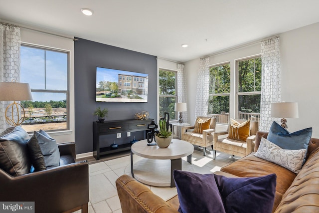 living room featuring recessed lighting, baseboards, and light tile patterned floors