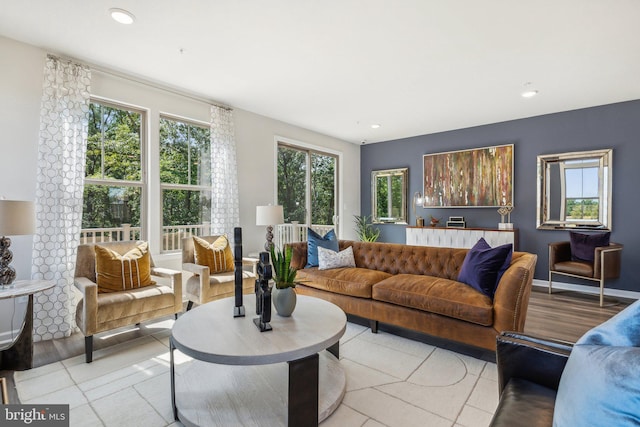 living area featuring baseboards, recessed lighting, and light tile patterned flooring