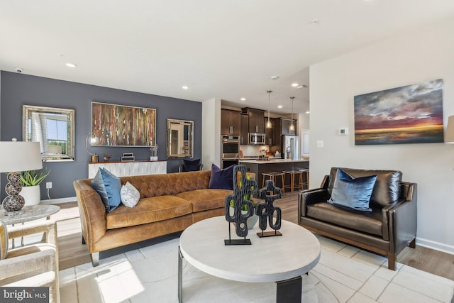living room with recessed lighting, baseboards, and light tile patterned floors