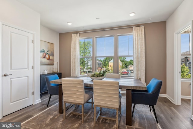 dining room featuring baseboards, recessed lighting, and wood finished floors
