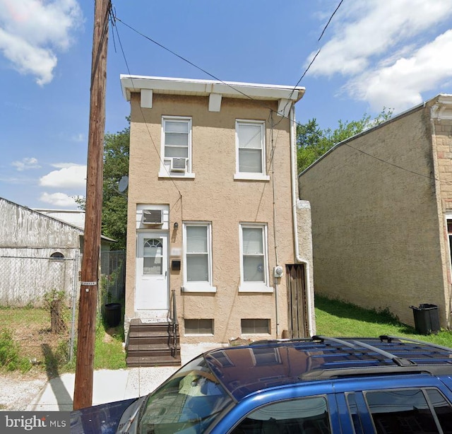 807 Spruce St, Camden, NJ 08103 - view of front facade featuring stucco siding, fence, and entry steps