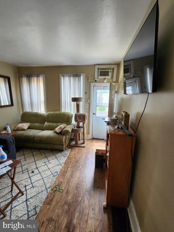 807 Spruce St, Camden, NJ 08103 - living area featuring wood finished floors and a wall unit AC