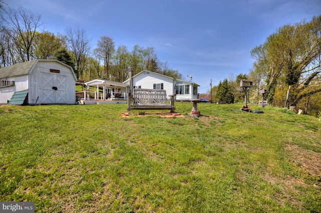 view of yard with a storage unit, an outdoor structure, and a wooden deck