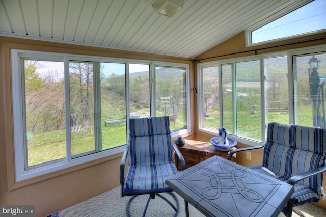 sunroom / solarium featuring lofted ceiling