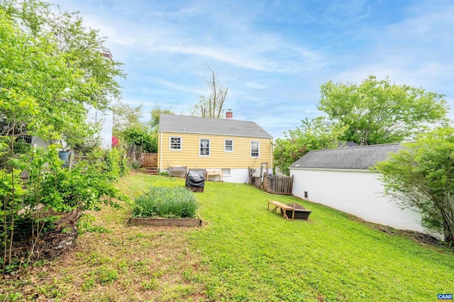 1210 Meriwether St, Charlottesville, VA 22902 - rear view of property featuring fence, a yard, and an outdoor fire pit