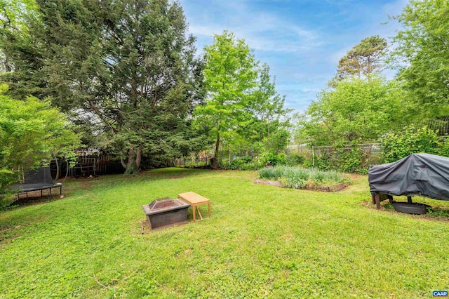 1210 Meriwether St, Charlottesville, VA 22902 - view of yard featuring fence, a trampoline, and an outdoor fire pit