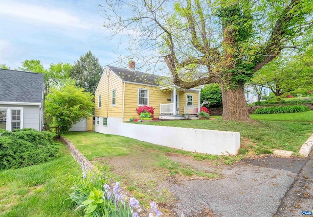 1210 Meriwether St, Charlottesville, VA 22902 - view of front facade featuring a front lawn, covered porch, and a chimney