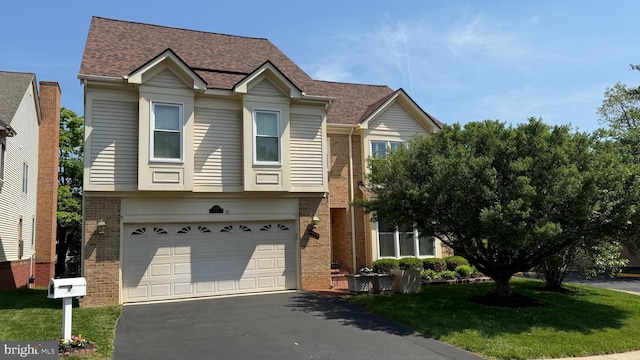 view of front of house with a front yard, roof with shingles, a garage, brick siding, and aphalt driveway