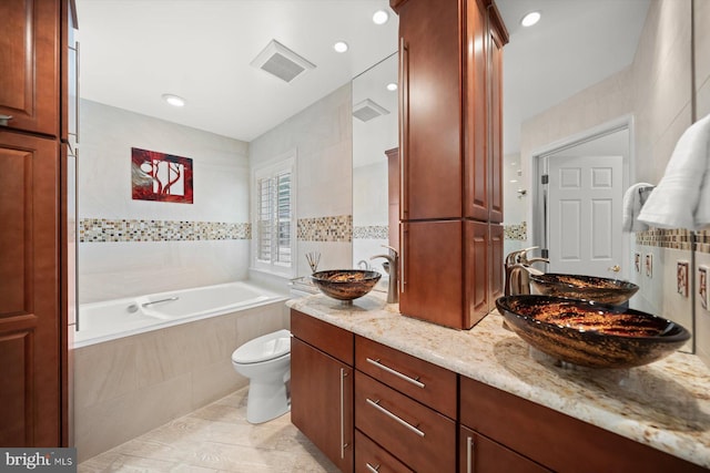 3422 Silver Maple Pl, Falls Church, VA 22042 - bathroom featuring tiled bath, tile walls, double vanity, toilet, and recessed lighting