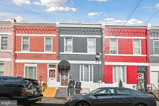 townhome / multi-family property featuring brick siding