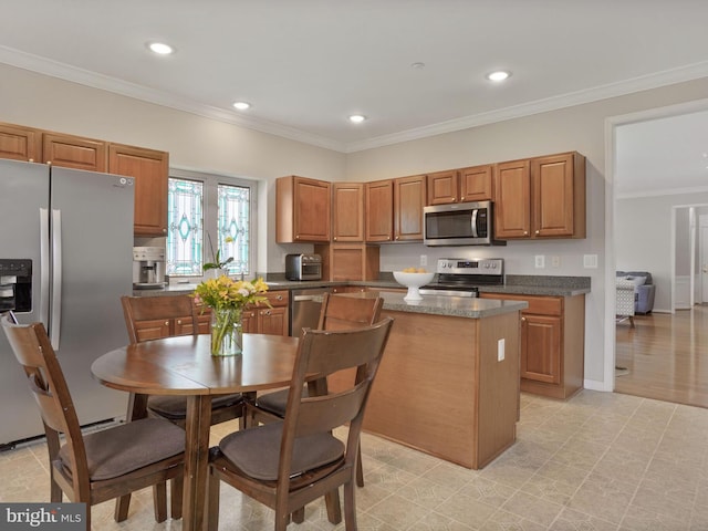 29 Norwood Ln, Fredericksburg, VA 22406 - kitchen featuring crown molding, appliances with stainless steel finishes, brown cabinetry, and a center island