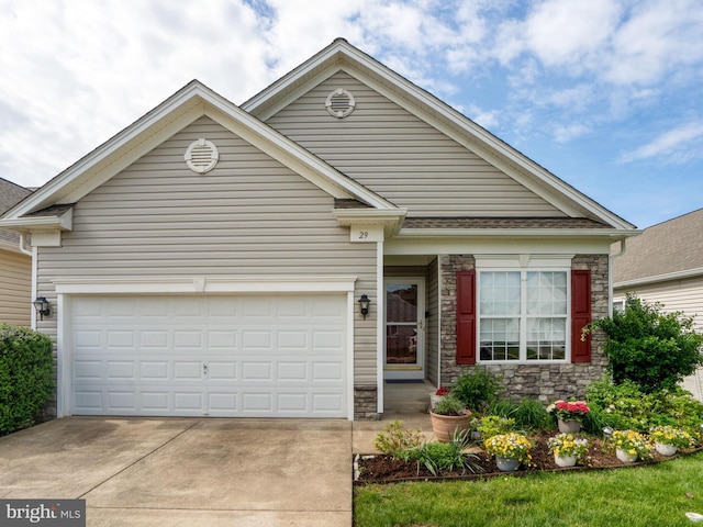 29 Norwood Ln, Fredericksburg, VA 22406 - view of front of house featuring a garage, stone siding, and concrete driveway