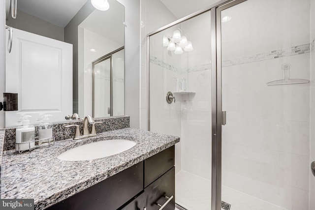 bathroom with a stall shower and vanity