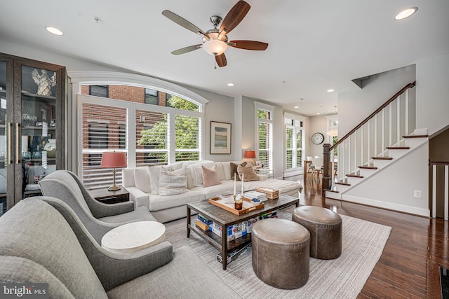 living room featuring wood finished floors, a ceiling fan, stairs, recessed lighting, and baseboards