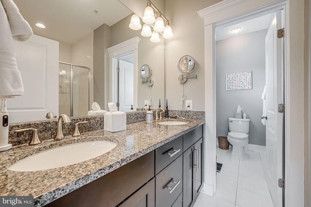 full bath with toilet, a stall shower, tile patterned floors, double vanity, and baseboards