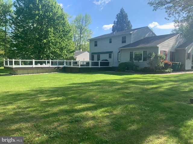 1246 Center St, Levittown, PA 19057 - back of house featuring a lawn and a wooden deck
