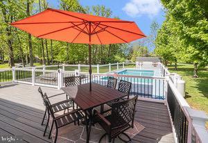 1246 Center St, Levittown, PA 19057 - wooden deck featuring a fenced in pool