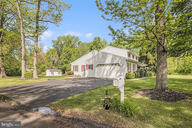 1246 Center St, Levittown, PA 19057 - view of side of home featuring a lawn, an attached garage, and driveway