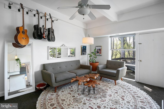 living room featuring ceiling fan and beamed ceiling